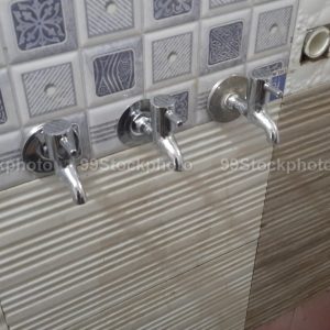 Three faucet installed on a wall in a Bathroom